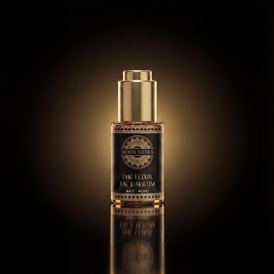 Moda Sutra 24K Elixir Face Serum — 30 mL apothecary bottle with real 24-karat gold foil, on warm black with antique-gold light.
